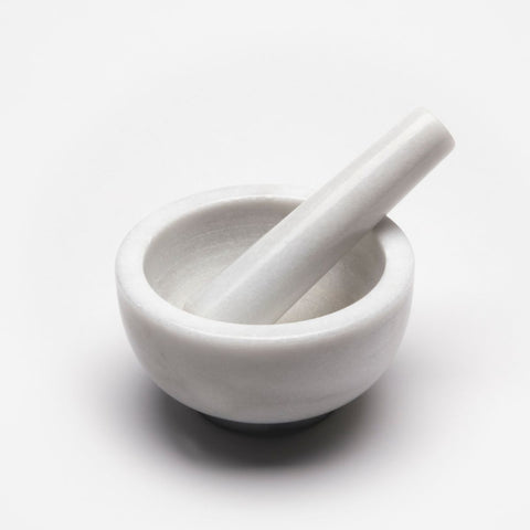 white mortar and pestle on a white table