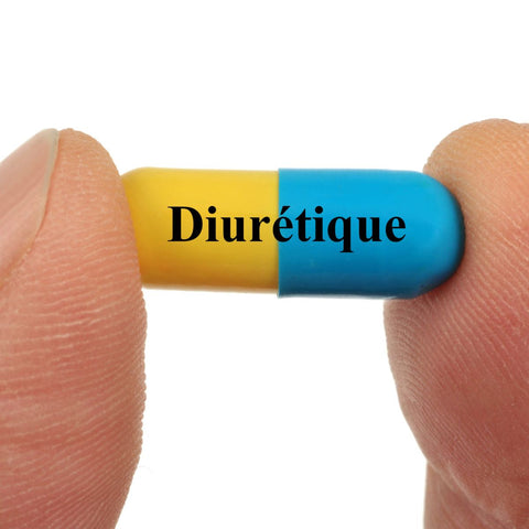 fingers holding a blue and yellow pill that says "diuretique" on it