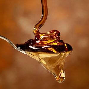 close up view of maple syrup being poured onto a spoon