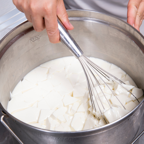 steaming milk with hand